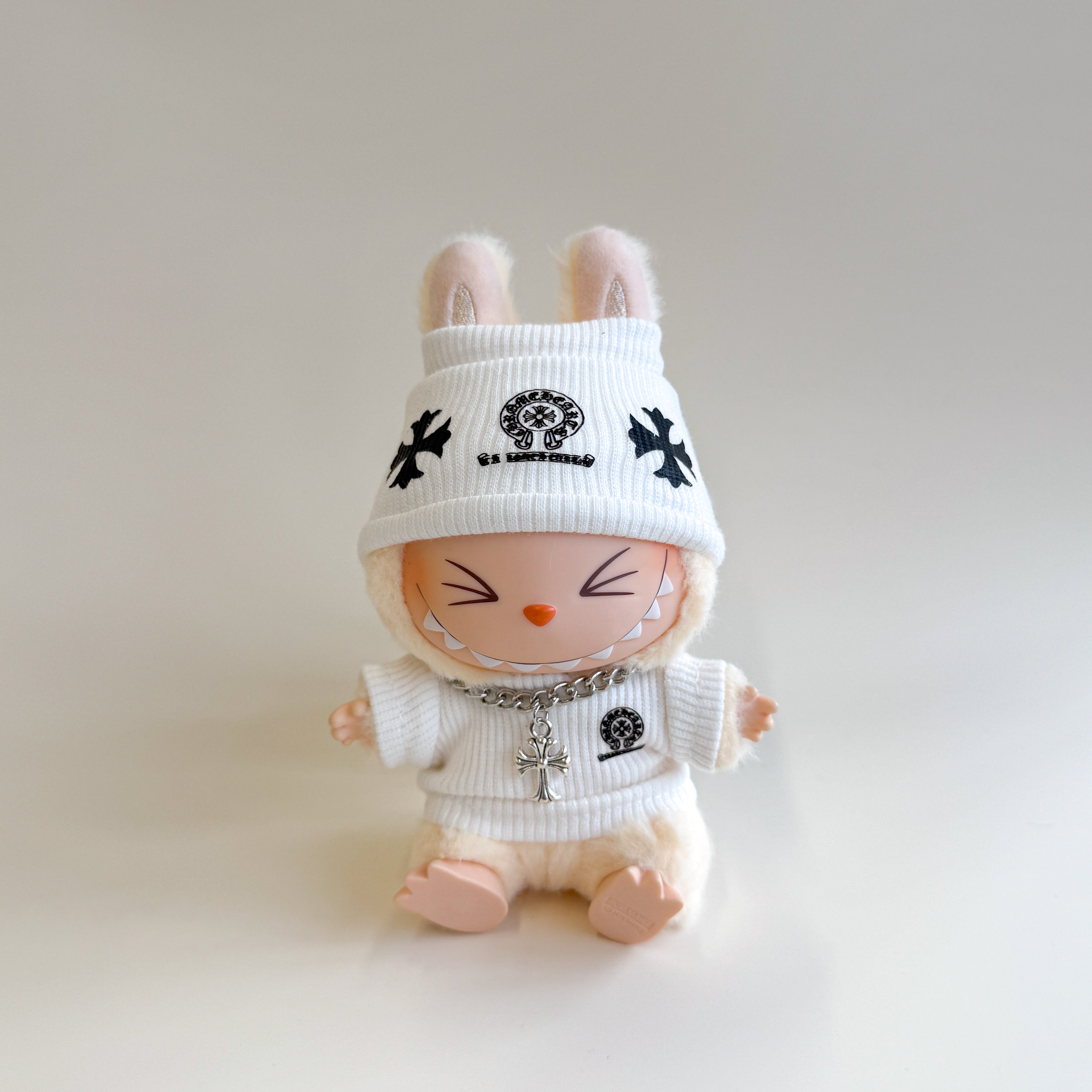 Labubu wearing Chrome H inspired knit sweater and cap