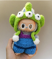 Labubu doll wearing cosmic alien blue overalls with monster hood
