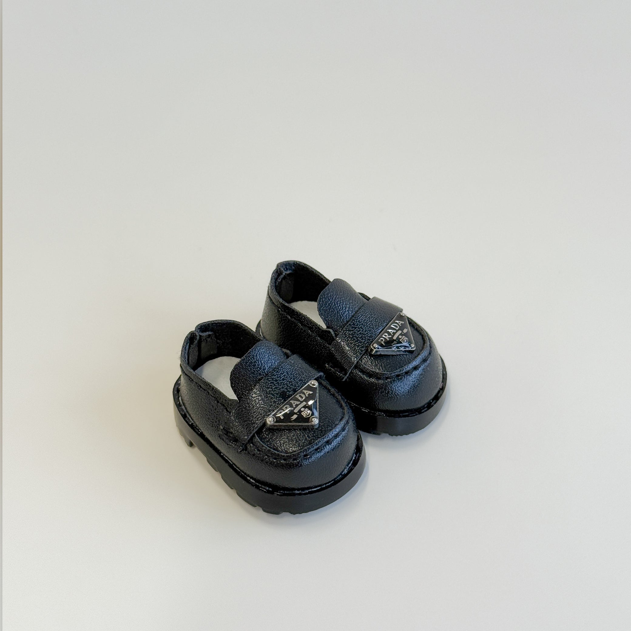 Front view of Labubu doll clothes luxury loafers in black inspired by P design