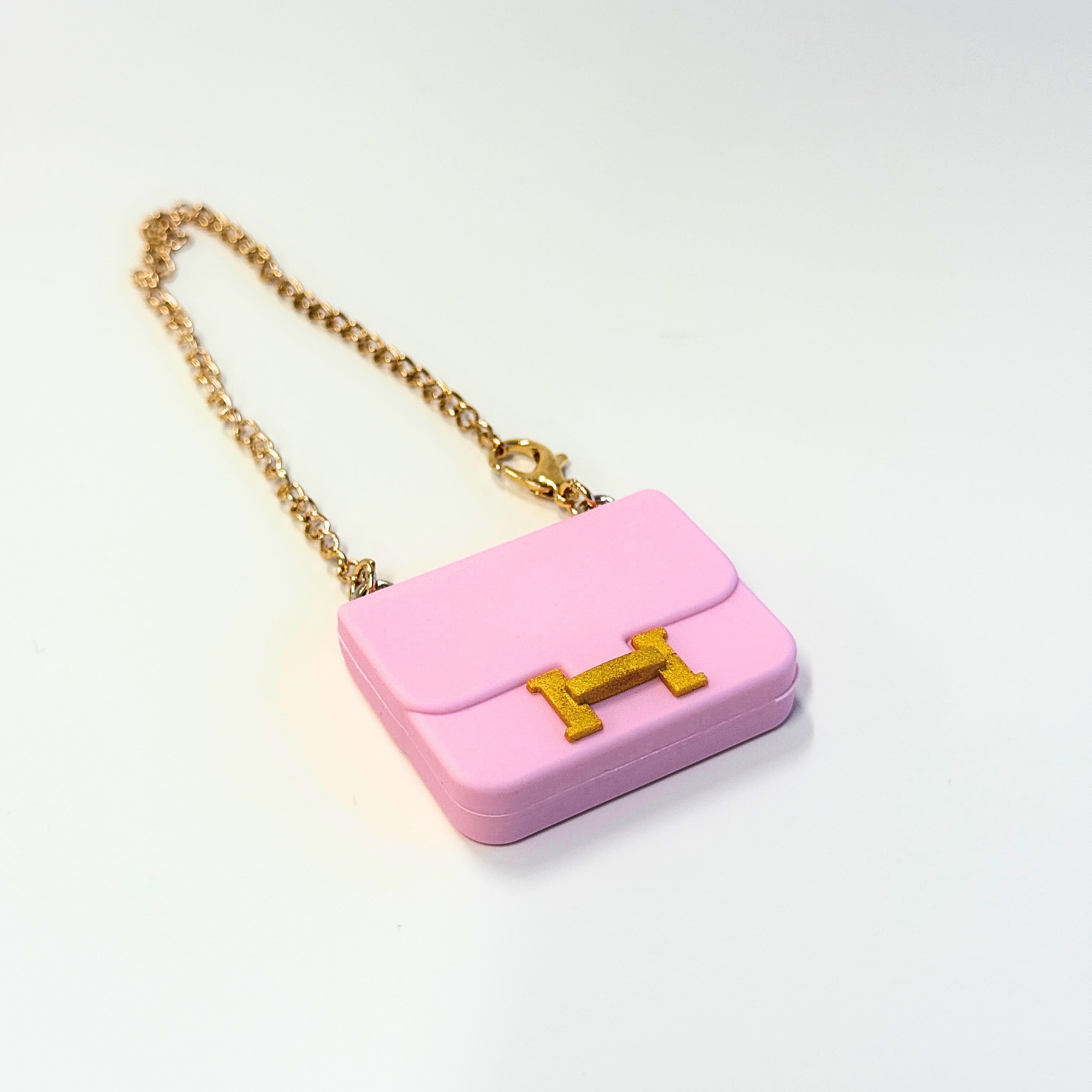 Front view of Labubu doll clothes mini Constance bag in pink with gold accent