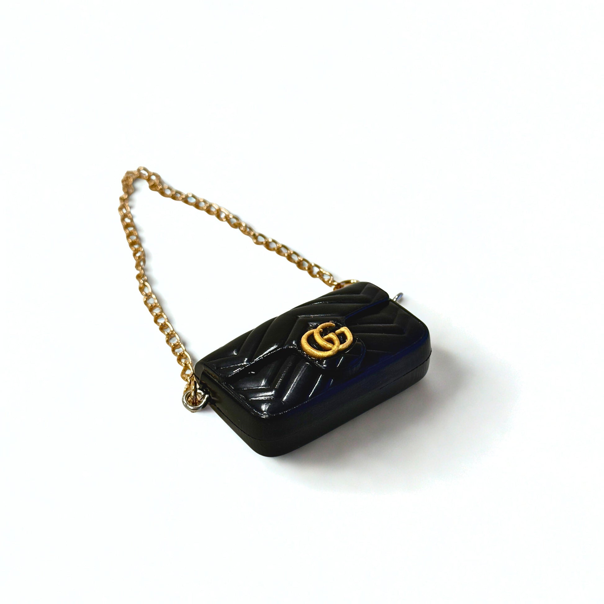 Front view of Labubu doll clothes mini quilted handbag in black with gold accent