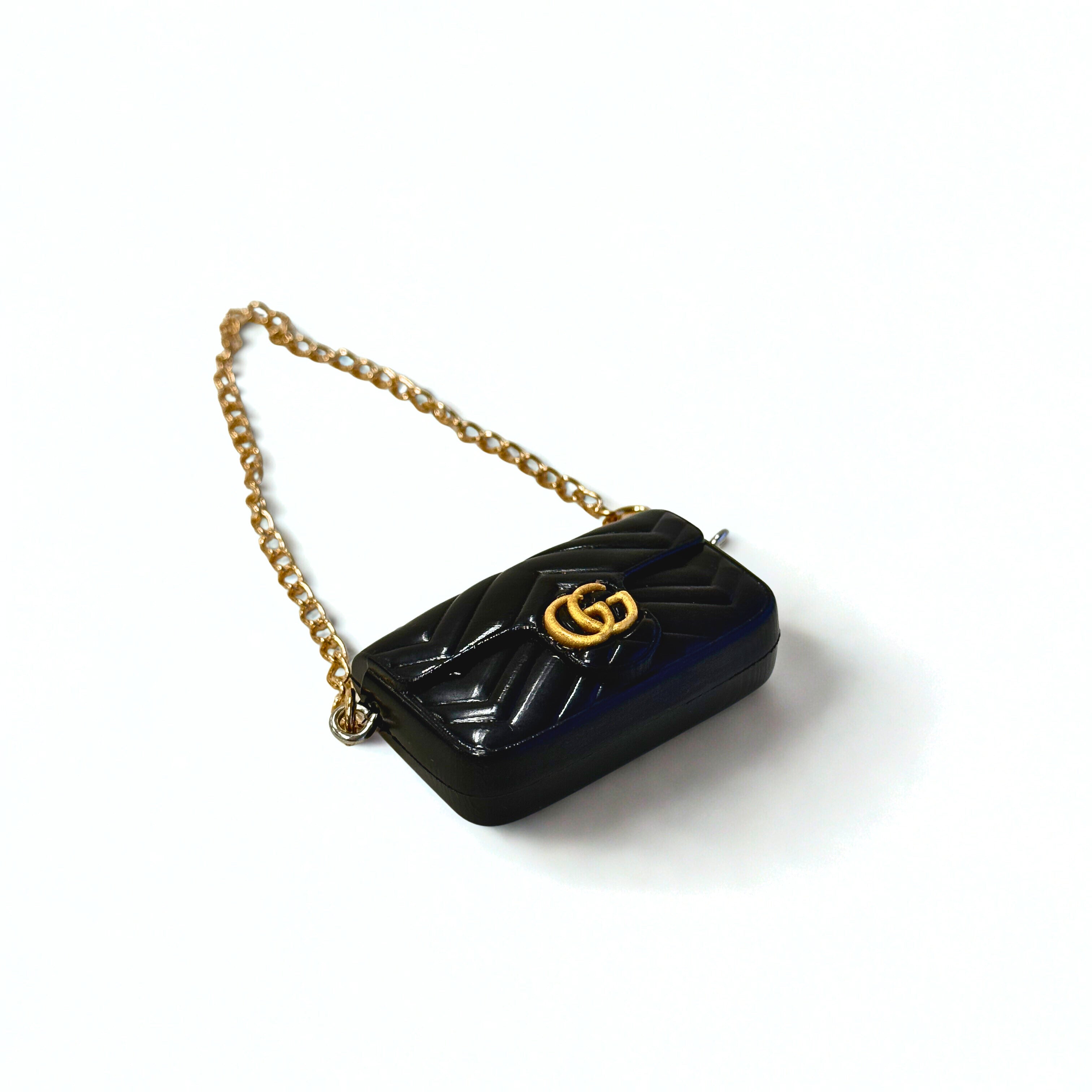 Front view of Labubu doll clothes mini quilted handbag in black with gold accent