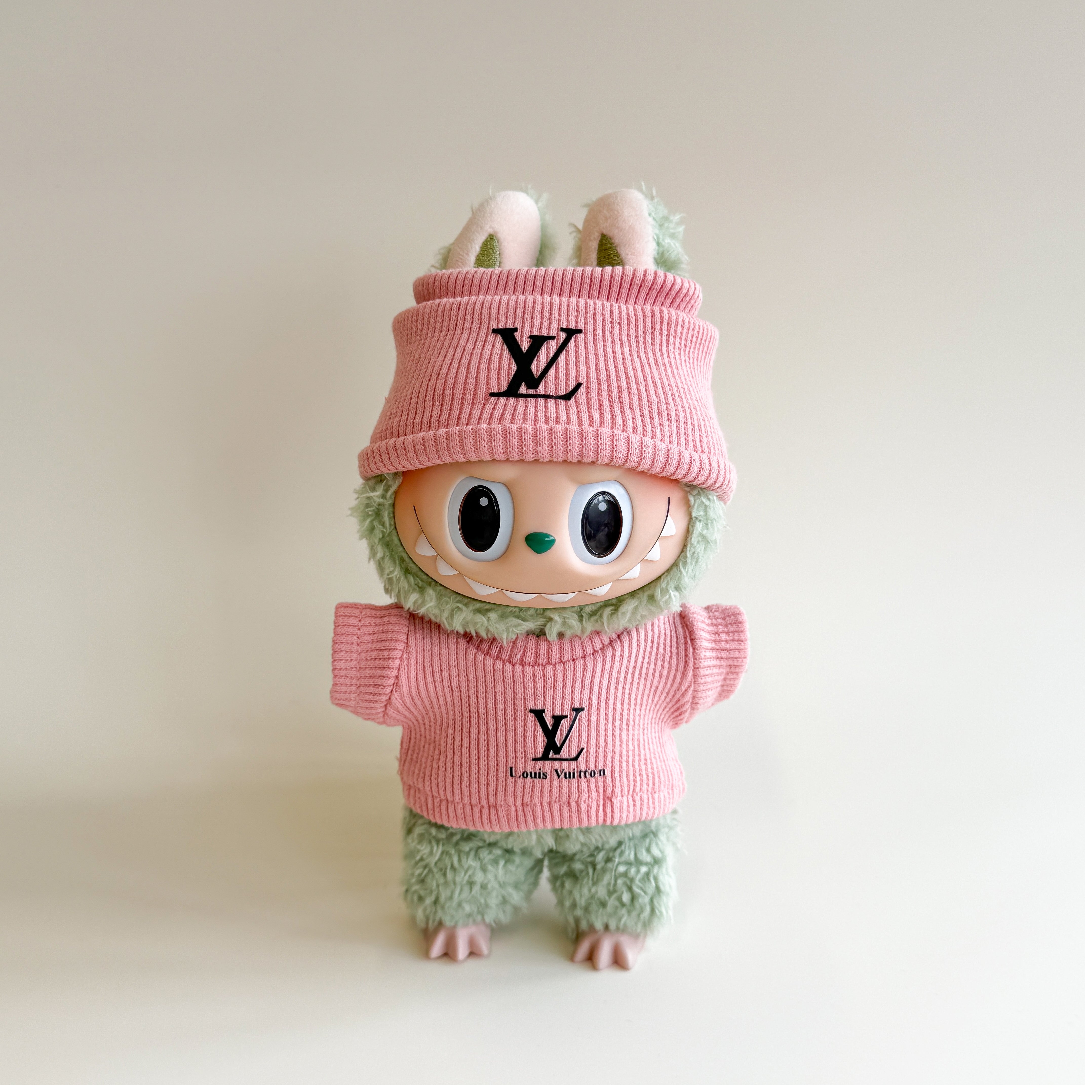 Front view of L.V. inspired Labubu doll winter clothes with monogram