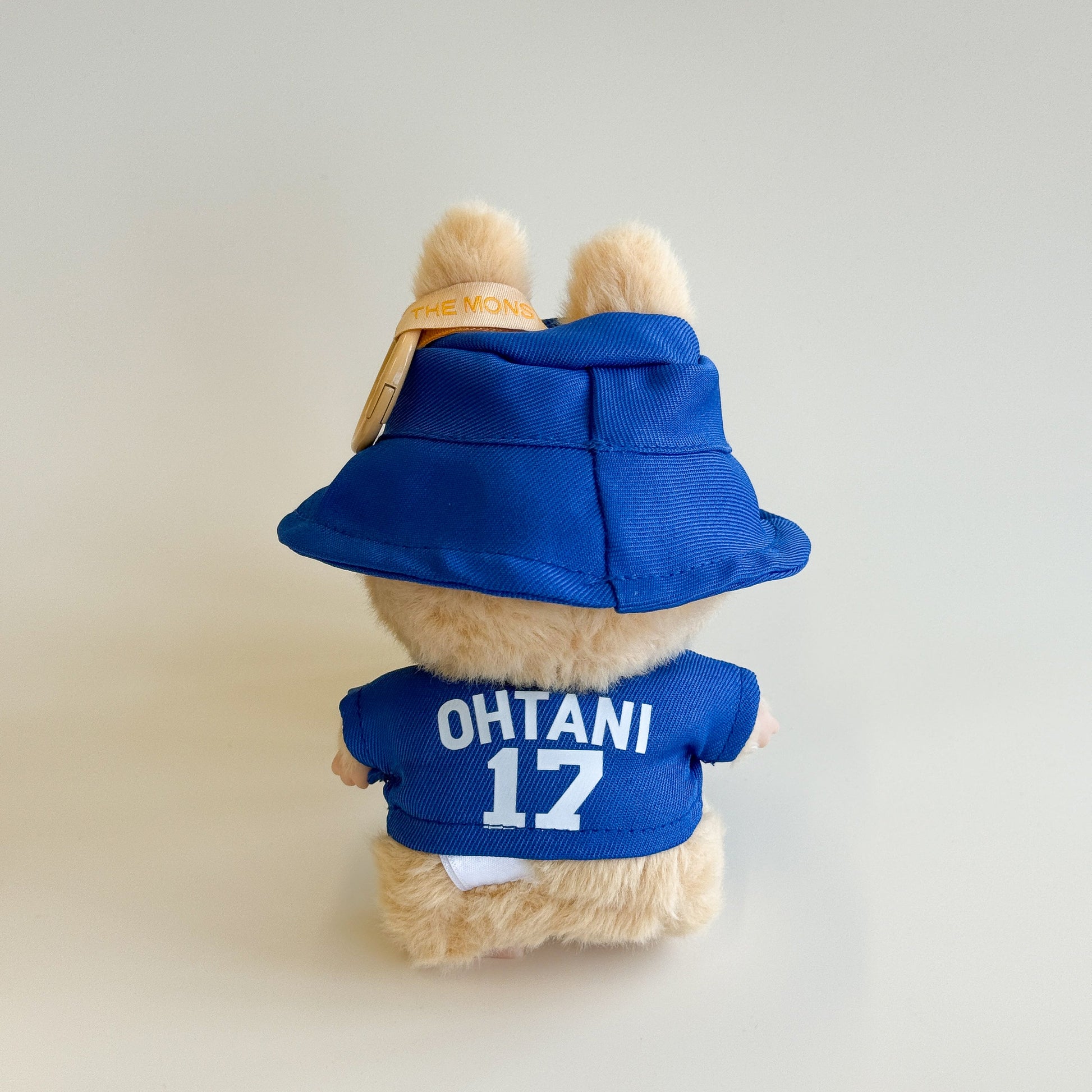 Side view of Labubu doll in baseball set