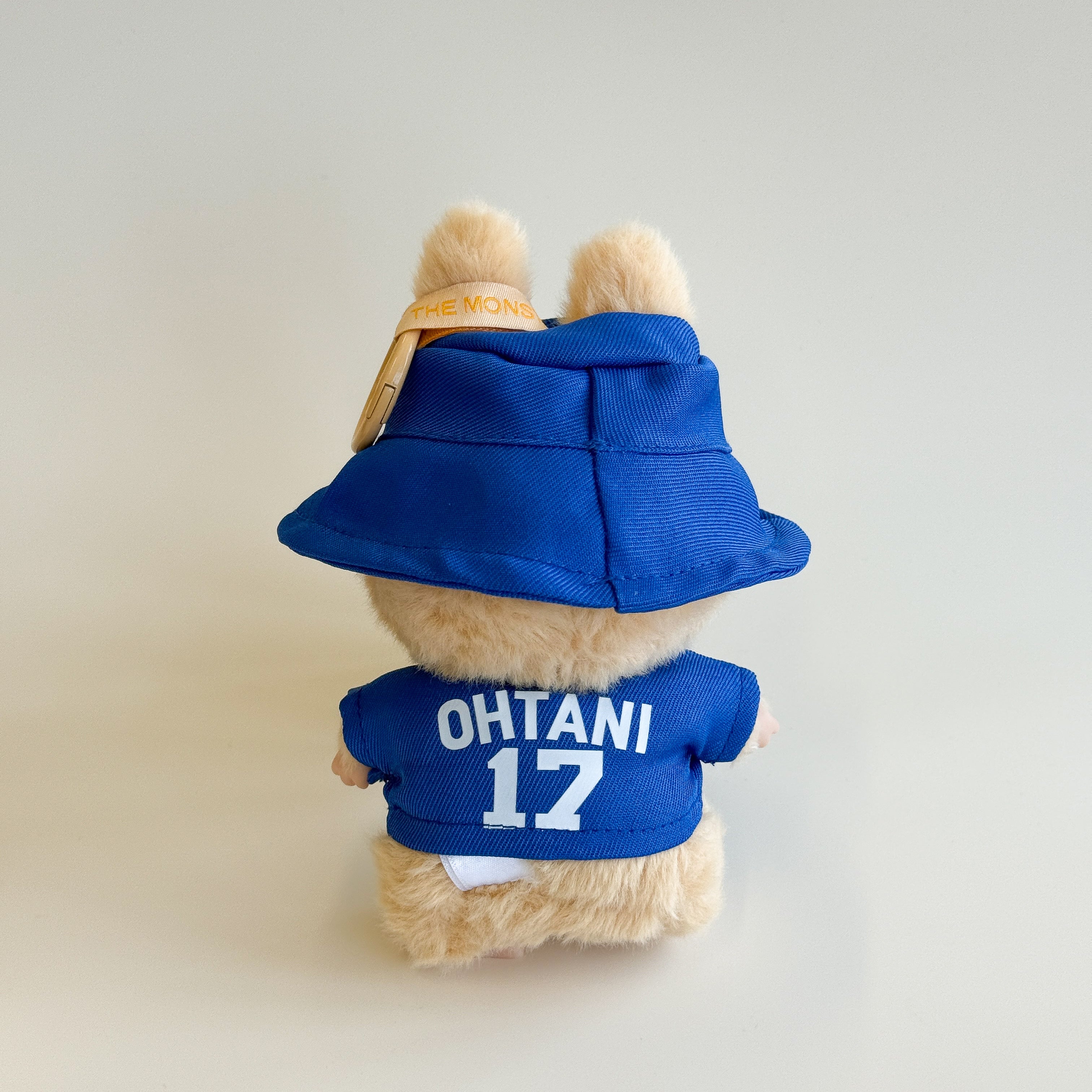 Side view of Labubu doll in baseball set