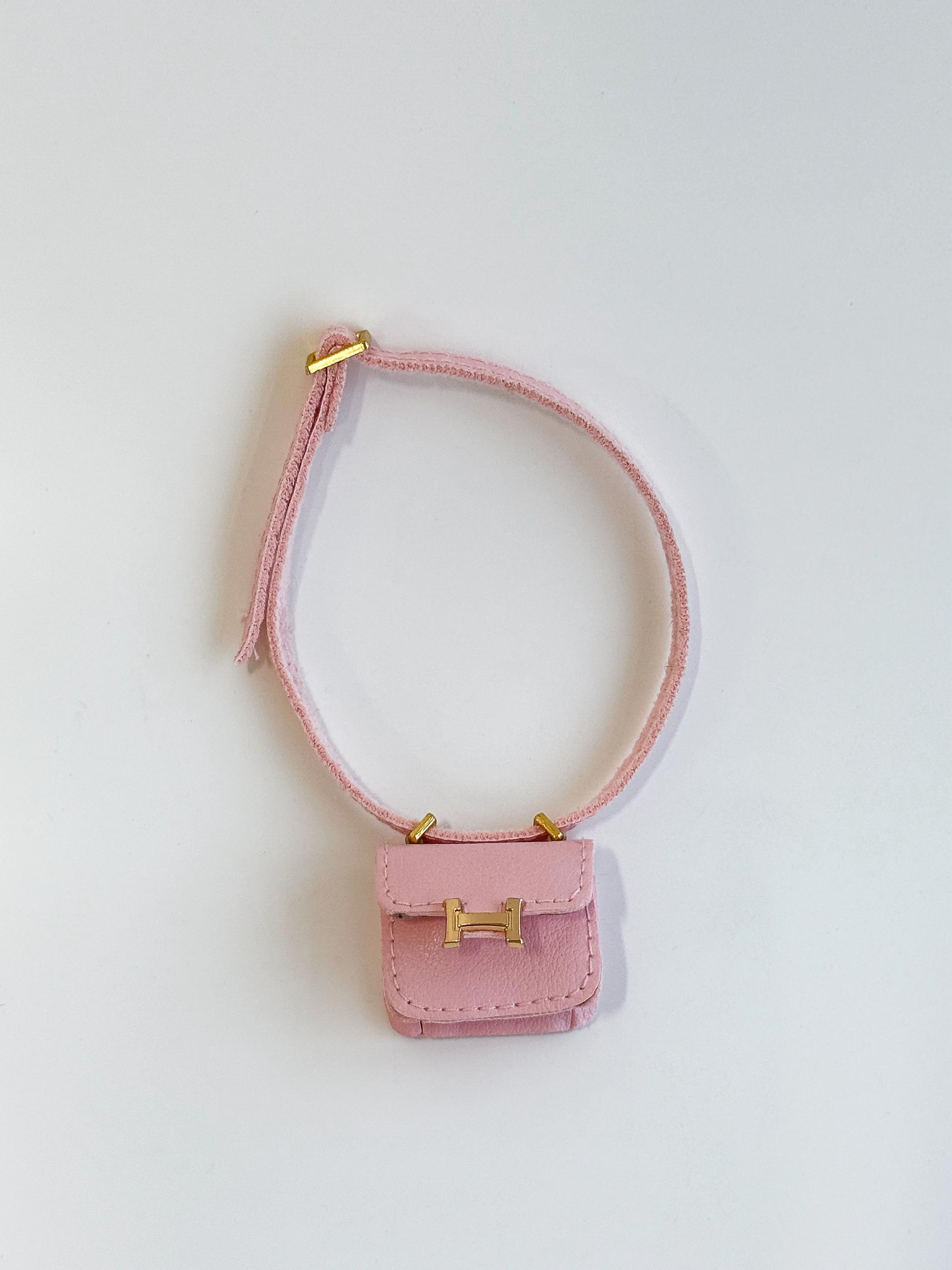 Labubu doll wearing pink mini micro flap crossbody bag
