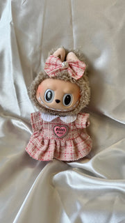 Labubu doll wearing pink tweed dress with pleated skirt