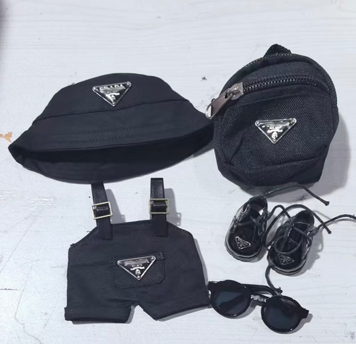 Back view of Labubu doll clothes showing overalls and backpack