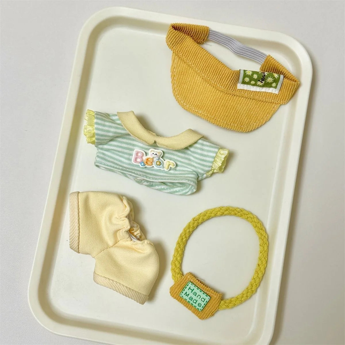 Side view of Labubu doll clothes with yellow hat and tee