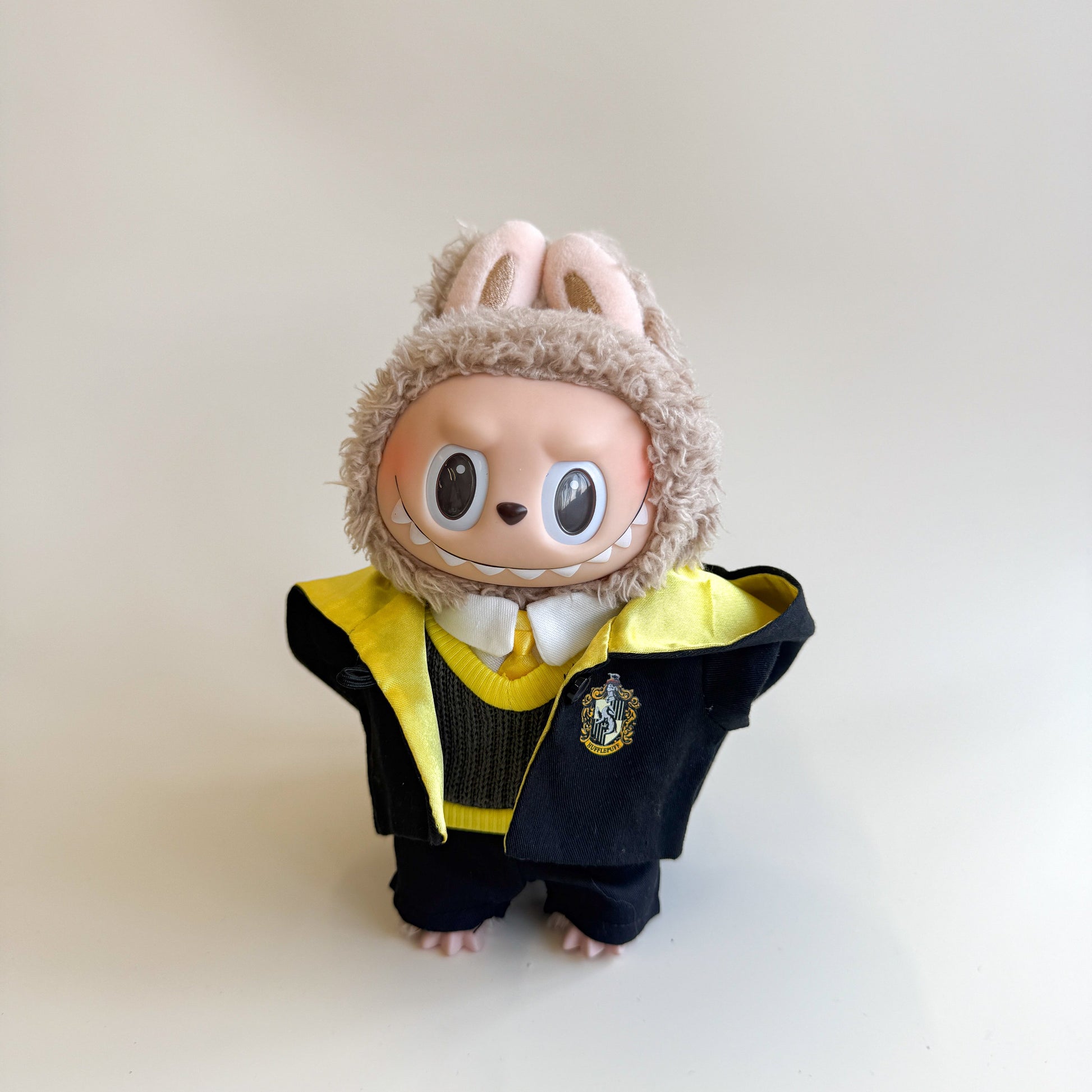Close-up detail of handcrafted design on Labubu doll clothes yellow wizard outfit