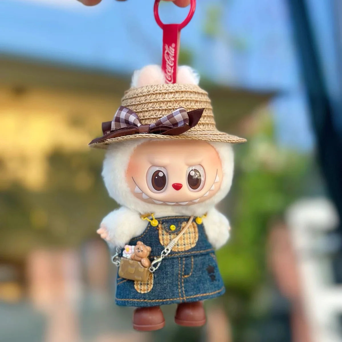 Front view of Labubu doll in denim skirt and hat