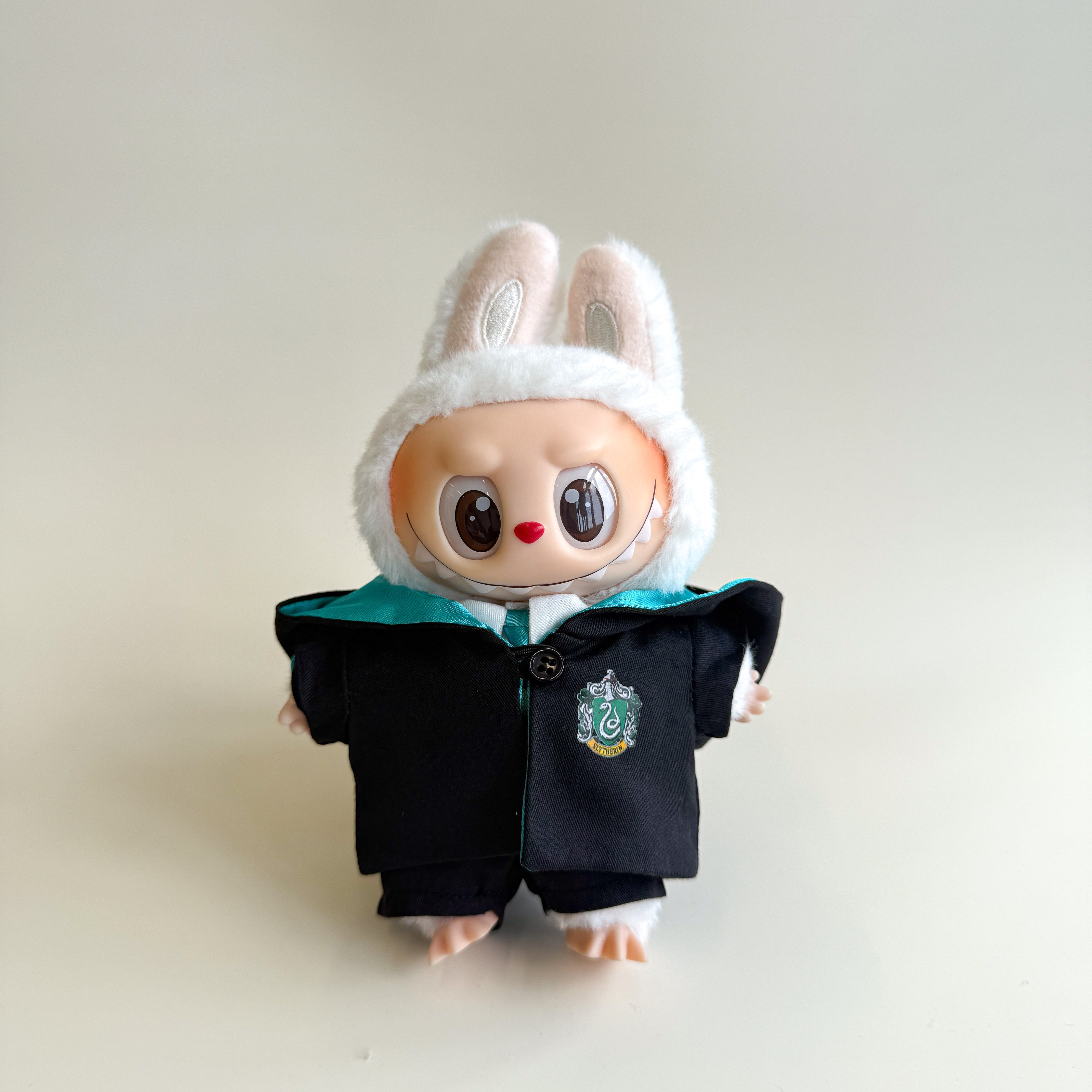 Labubu doll wearing green wizard cloak